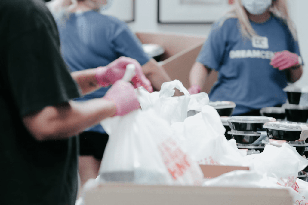 People volunteering at a charity after a business received donations to show customer appreciation