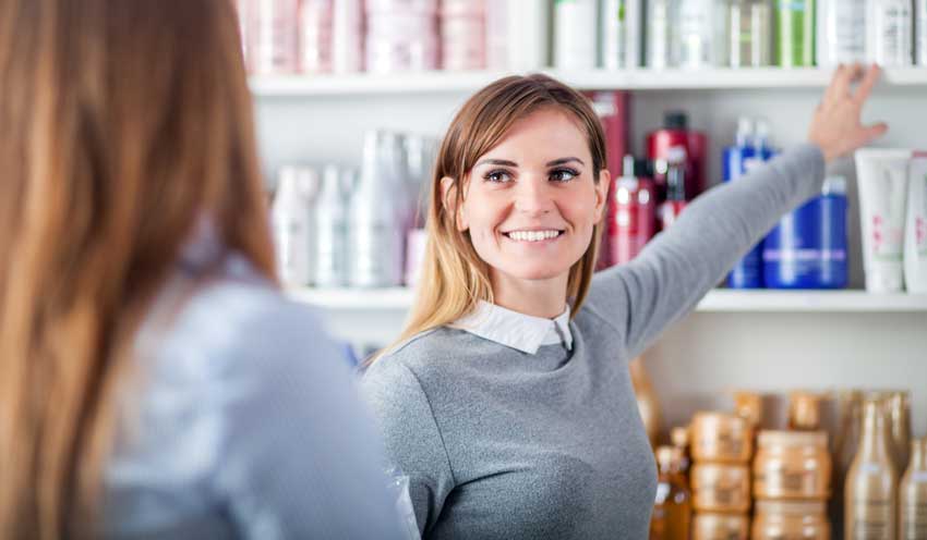 Salesperson in salon demonstrating marketing with the customer in mind